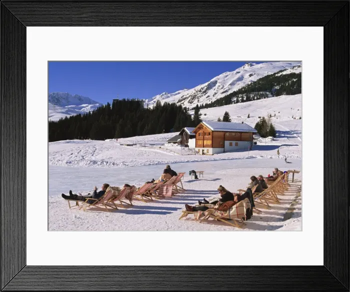 Framed Print : Tourists in deck chairs on the snow in winter Framed Print : Tourists in deck chairs on the snow in winter