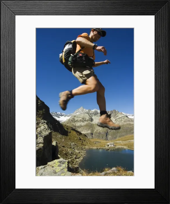 Framed Print : Hiker running on trail above lake at Schwarzee Paradise Framed Print : Hiker running on trail above lake at Schwarzee Paradise