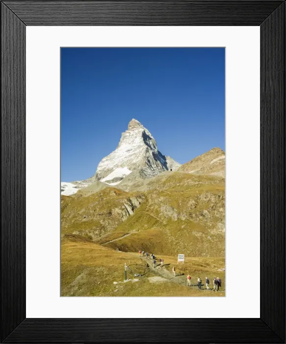 Framed Print : Line of hikers walking on trail near the Matterhorn Framed Print : Line of hikers walking on trail near the Matterhorn