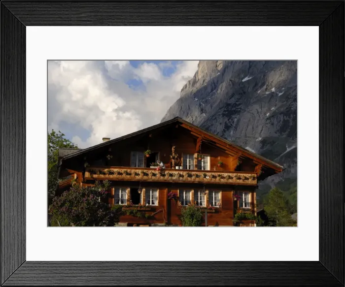Framed Print : Lady watering flowers on chalet