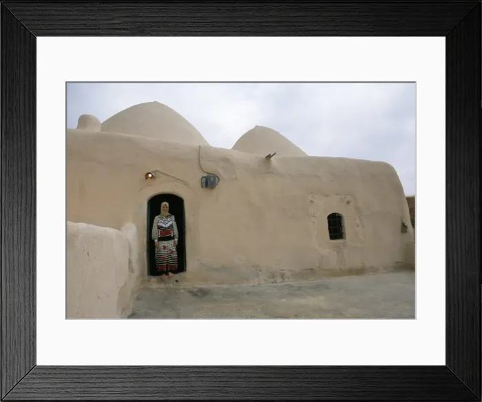 Framed Print : Woman in doorway of a 200 year old beehive house in the desert Framed Print : Woman in doorway of a 200 year old beehive house in the desert