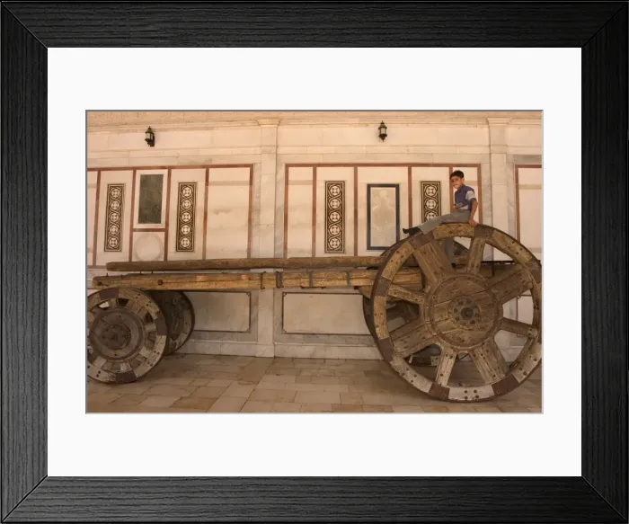 Framed Print : Boy on top of big wheeled cart Framed Print : Boy on top of big wheeled cart