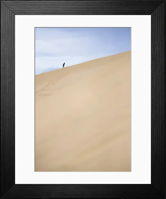 Framed Print : Tourist climbing Te Paki Sand Dunes on 90 Mile Beach, Northland, North Island, New Zealand Framed Print : Tourist climbing Te Paki Sand Dunes on 90 Mile Beach, Northland, North Island, New Zealand