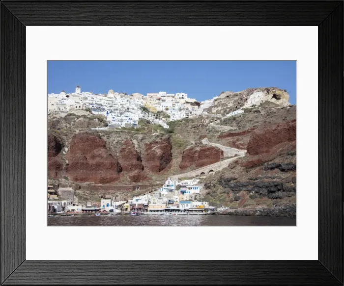 Framed Print : Typical Greek village perched on volcanic rock with white and blue houses and windmills Framed Print : Typical Greek village perched on volcanic rock with white and blue houses and windmills