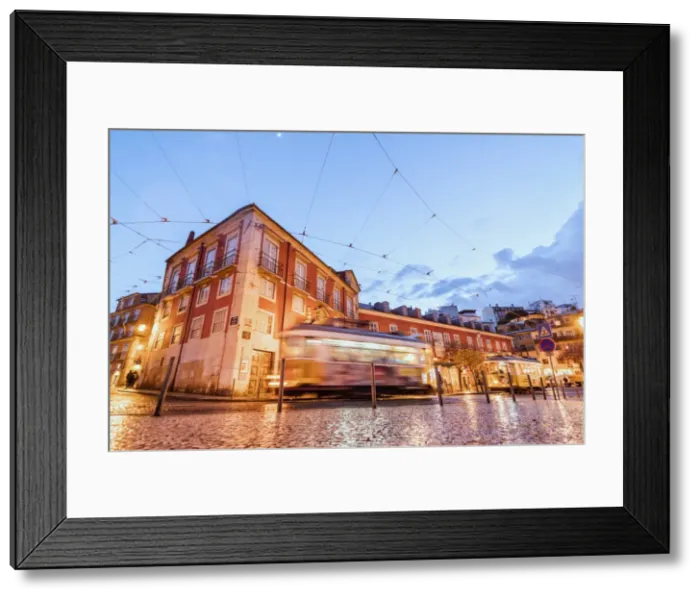 Framed Print : City lights on the typical architecture and old streets at dusk while the tram 28 proceeds Framed Print : City lights on the typical architecture and old streets at dusk while the tram 28 proceeds