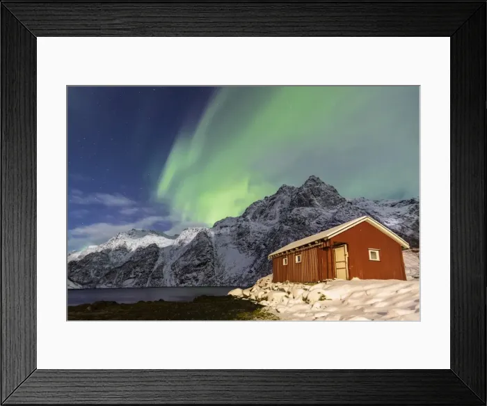 Framed Print : Northern Lights (aurora borealis) illuminate snowy peaks and the wooden cabin Framed Print : Northern Lights (aurora borealis) illuminate snowy peaks and the wooden cabin