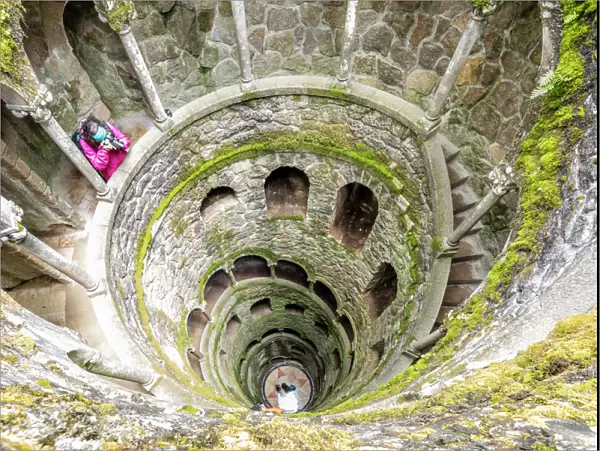 Photographer at the top of the spiral stairs inside the towers of Initiation Well