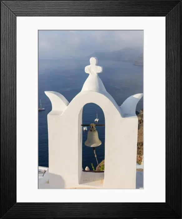 Framed Print : The white steeple of the church and the blue Aegean Sea as symbols of Greece, Oia Framed Print : The white steeple of the church and the blue Aegean Sea as symbols of Greece, Oia