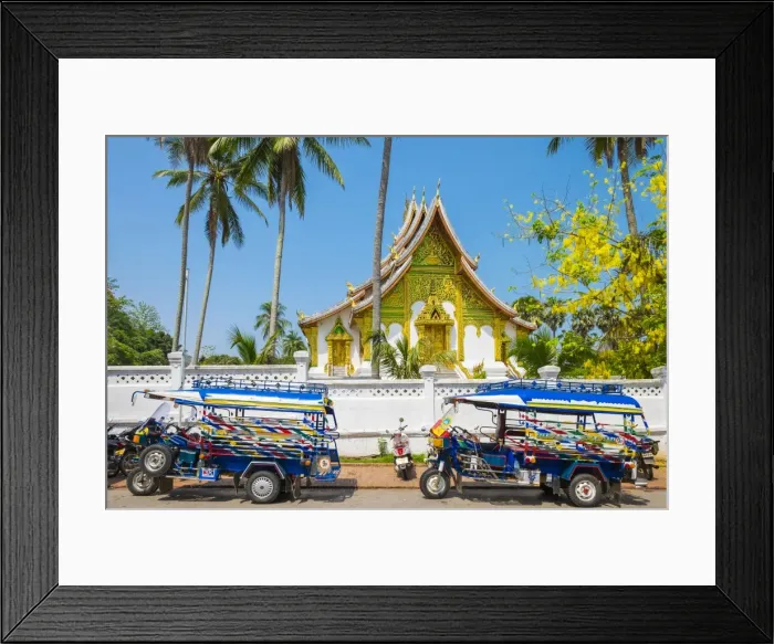 Framed Print : Colorful tuk-tuks in front of Haw Pha Bang temple on the grounds of the Royal Palace Framed Print : Colorful tuk-tuks in front of Haw Pha Bang temple on the grounds of the Royal Palace