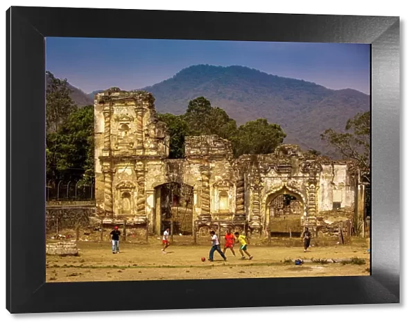 Kids playing soccer at ruins in Antigua, Guatemala, Central America
