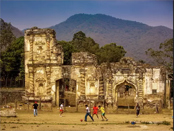 Kids playing soccer at ruins in Antigua, Guatemala, Central America