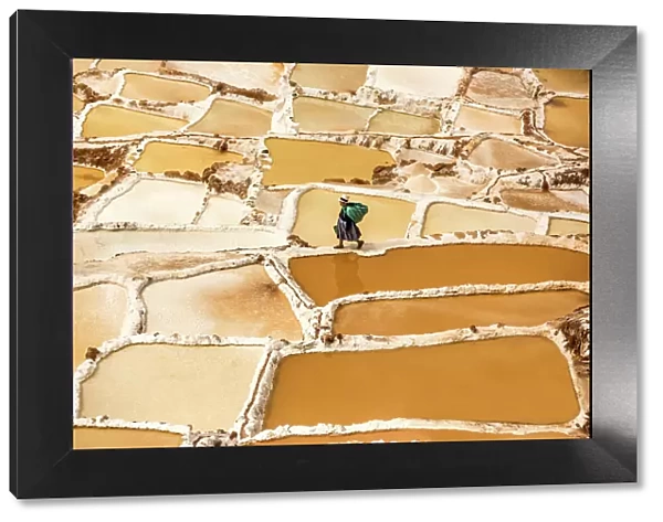 Woman mining salt, Salineras de Maras, Maras Salt Flats, Sacred Valley, Peru, South