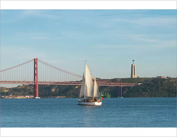 Sailboat navigating on the Tagus River near the Ponte 25 de Abril, Belem, Lisbon