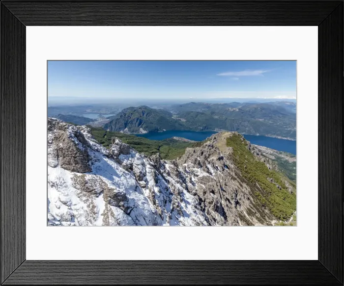 Framed Print : Aerial view of the snowy ridges of the Grignetta mountain with Lake Como in the background Framed Print : Aerial view of the snowy ridges of the Grignetta mountain with Lake Como in the background