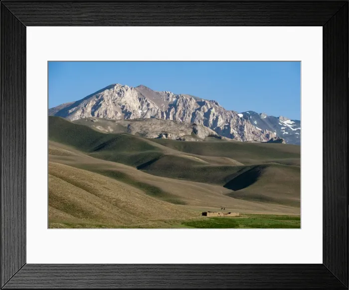 Framed Print : A distant house in the grasslands with views of mountains in the distance, Bamiyan province Framed Print : A distant house in the grasslands with views of mountains in the distance, Bamiyan province