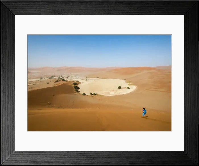 Framed Print : A woman runs down from the summit of Sossusvlei sand dune, Namibia, Africa Framed Print : A woman runs down from the summit of Sossusvlei sand dune, Namibia, Africa