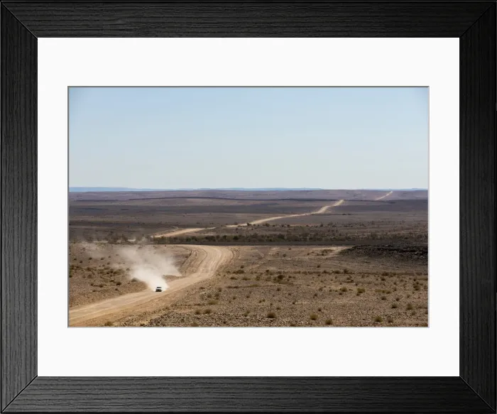Framed Print : A car leaves a cloud of dust as it apporachs along the long dusty road from the Fish River Canyon Framed Print : A car leaves a cloud of dust as it apporachs along the long dusty road from the Fish River Canyon