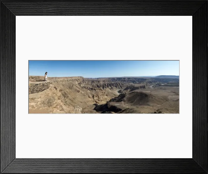 Framed Print : A woman looks into The Fish River Canyon in southern Namibia, Africa Framed Print : A woman looks into The Fish River Canyon in southern Namibia, Africa