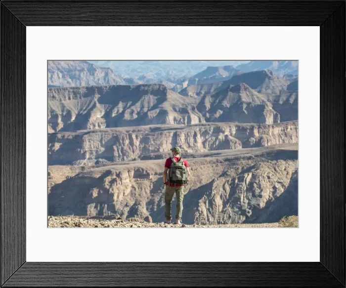 Framed Print : A man stands on the edge of the Fish River Canyon, Namibia, Africa Framed Print : A man stands on the edge of the Fish River Canyon, Namibia, Africa