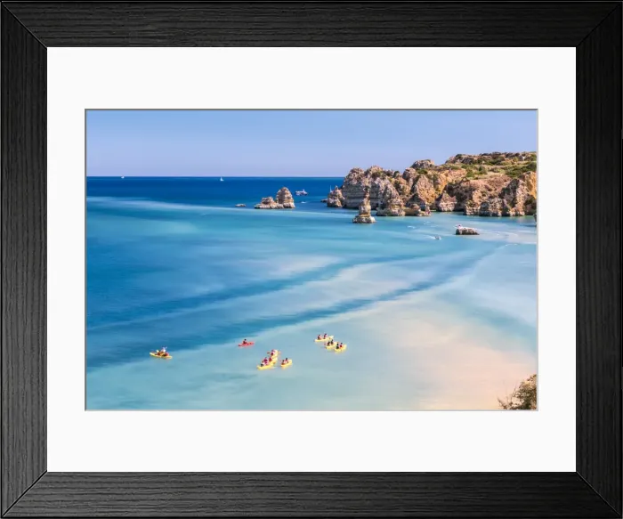 Framed Print : Canoes in the turquoise water of the Atlantic Ocean surrounding Praia Dona Ana beach Framed Print : Canoes in the turquoise water of the Atlantic Ocean surrounding Praia Dona Ana beach