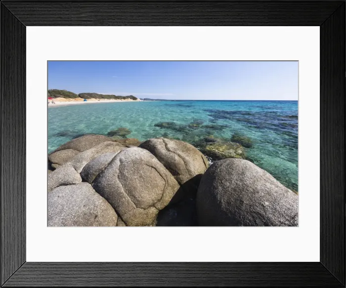 Framed Print : Rocks frame the turquoise water of sea around the sandy beach of Sant Elmo Castiadas Framed Print : Rocks frame the turquoise water of sea around the sandy beach of Sant Elmo Castiadas
