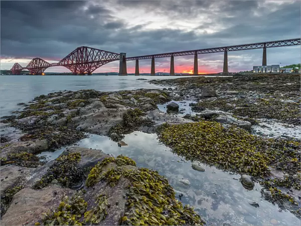 Dawn breaks over the Forth Rail Bridge, UNESCO World Heritage Site, and the Firth of Forth