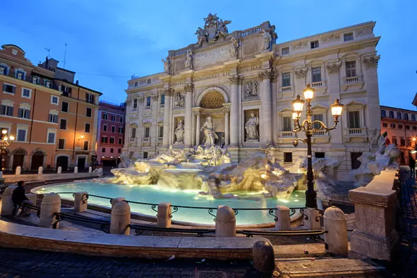 View of Trevi Fountain illuminated by street lamps and the lights of dusk, Rome, Lazio