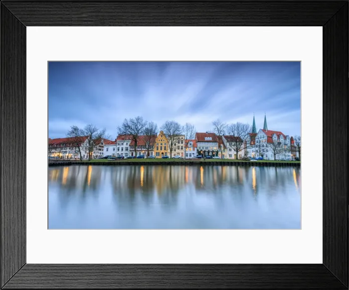 Framed Print : Clouds on the typical houses and towers of cathedral reflected in River Trave at dusk Framed Print : Clouds on the typical houses and towers of cathedral reflected in River Trave at dusk