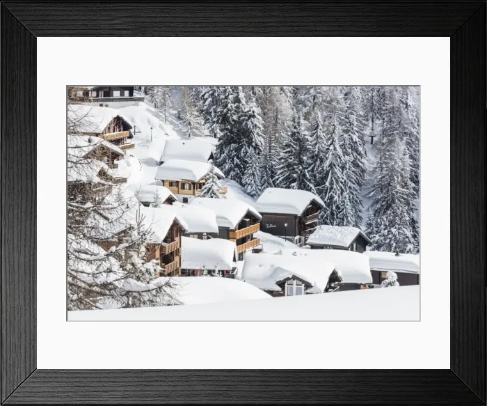 Framed Print : The snowy woods frame the typical mountain huts, Bettmeralp, district of Raron, canton of Valais Framed Print : The snowy woods frame the typical mountain huts, Bettmeralp, district of Raron, canton of Valais