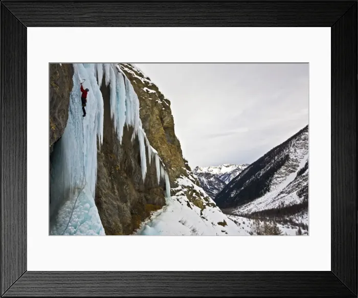 Framed Print : An ice climber ascending a frozen cascade in the Fournel Valley, Ecrins Massif, France