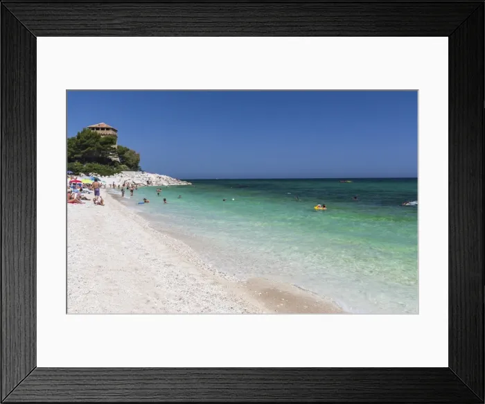 Framed Print : Tourists on the beach framed by the turquoise sea, Province of Ancona, Conero Riviera Framed Print : Tourists on the beach framed by the turquoise sea, Province of Ancona, Conero Riviera