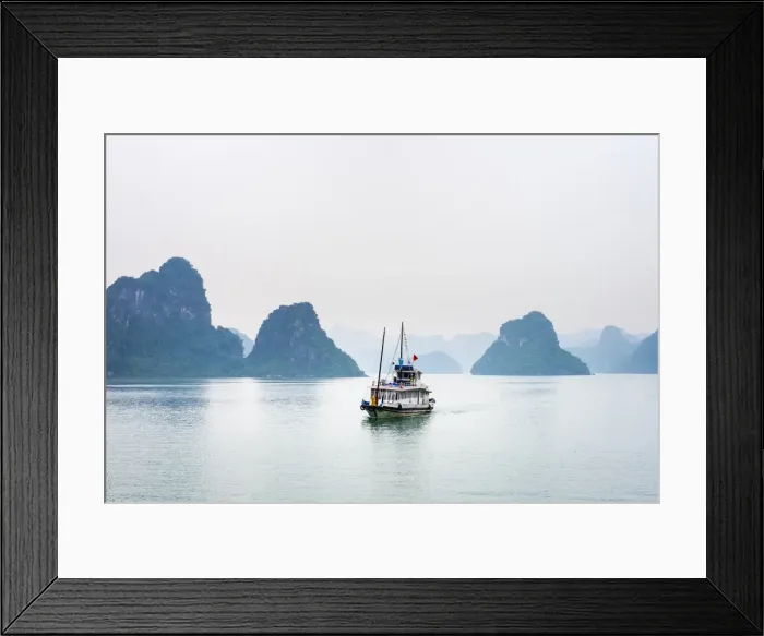 Framed Print : A boat passes through foggy karst landscape in Ha Long Bay, Quang Ninh Province, Vietnam Framed Print : A boat passes through foggy karst landscape in Ha Long Bay, Quang Ninh Province, Vietnam