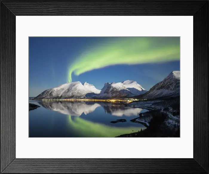 Framed Print : Northern lights (aurora borealis) and stars light up the snowy peaks reflected in the cold sea