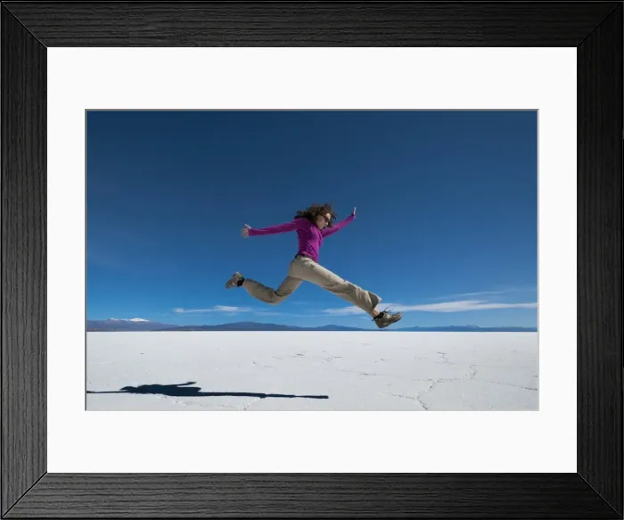 Framed Print : A girl leaps into the air at the Salinas Grandes (salt flats) near Purmamarca, Argentina Framed Print : A girl leaps into the air at the Salinas Grandes (salt flats) near Purmamarca, Argentina