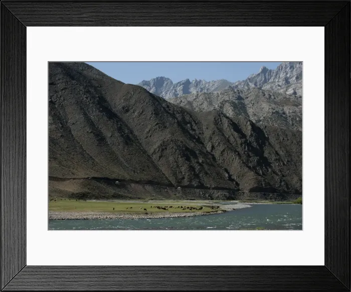 Framed Print : Goats graze along the riverbank of the Panjshir River in Afghanistan, Asia Framed Print : Goats graze along the riverbank of the Panjshir River in Afghanistan, Asia