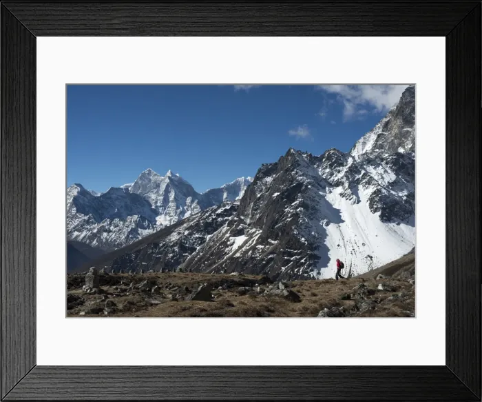 Framed Print : A trekker in the Everest region on the way up to Everest Base Camp seen here walking Framed Print : A trekker in the Everest region on the way up to Everest Base Camp seen here walking