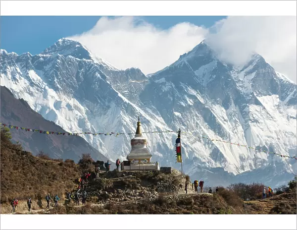 Hoards of trekkers make their way to Everest Base Camp, Mount Everest is the peak on the left