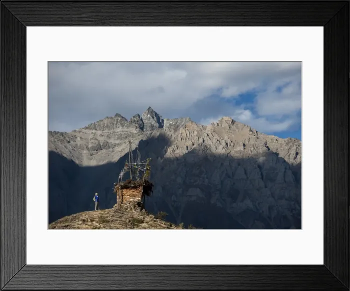 Framed Print : A small chorten strewn with prayer flags marks the top of a hill near Ringmo in Framed Print : A small chorten strewn with prayer flags marks the top of a hill near Ringmo in