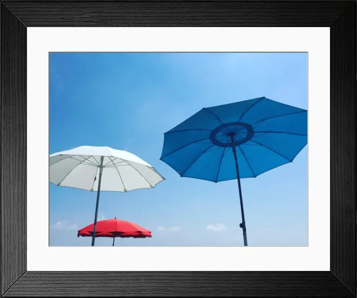 Framed Print : Red, white and blue beach parasols against a blue sky, Nice, Alpes Maritimes, Cote d Azur Framed Print : Red, white and blue beach parasols against a blue sky, Nice, Alpes Maritimes, Cote d Azur