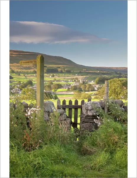 A footpath signpost and gate leading to Hawes village in Wensleydale, The Yorkshire Dales