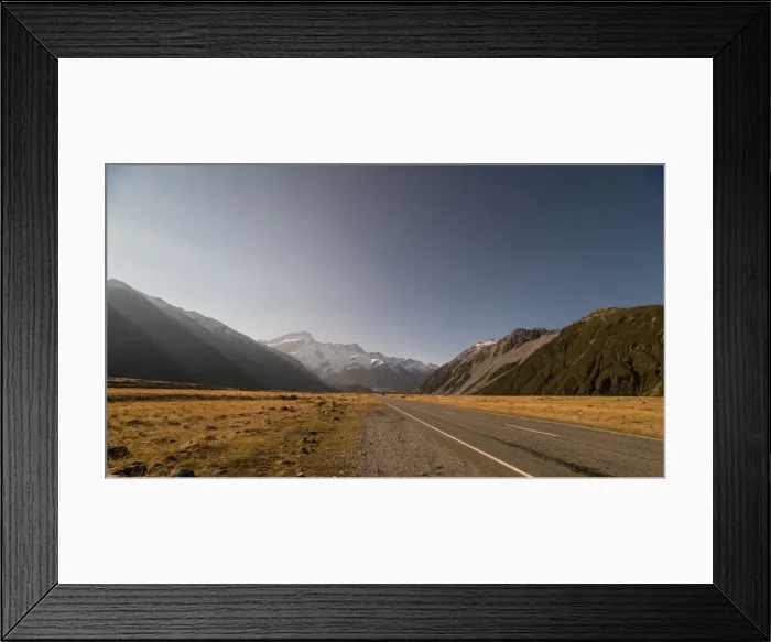 Framed Print : Late afternoon sun over a long straight road into the mountains, South Island, New Zealand Framed Print : Late afternoon sun over a long straight road into the mountains, South Island, New Zealand