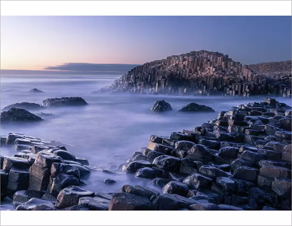 The Giants Causeway rises out of the Atlantic late at night as the last light of