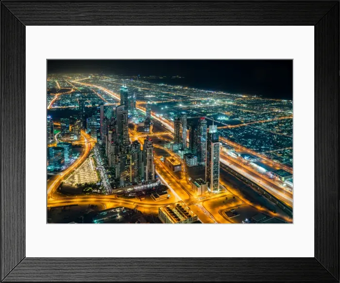 Framed Print : The street lights and skyscrapers of Dubai are seen at night from high above the city Framed Print : The street lights and skyscrapers of Dubai are seen at night from high above the city