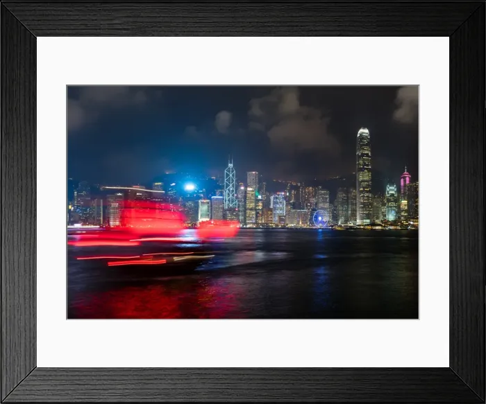 Framed Print : A red junk sailboat glides in front of the Hong Kong skyline at night, Hong Kong Framed Print : A red junk sailboat glides in front of the Hong Kong skyline at night, Hong Kong