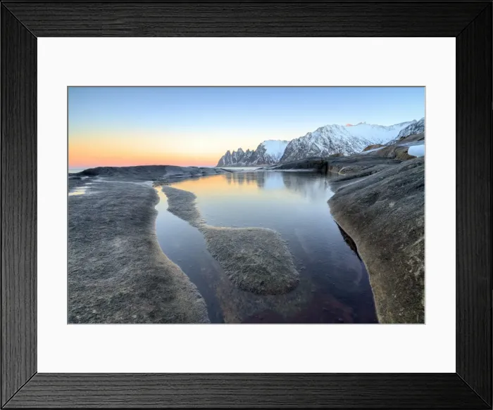 Framed Print : Orange sky at sunset reflected on snowy peaks and the frozen sea surrounded by rocks Tungeneset Framed Print : Orange sky at sunset reflected on snowy peaks and the frozen sea surrounded by rocks Tungeneset