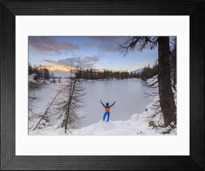 Framed Print : Hiker admires Lago Azzurro completely frozen at dawn, Spluga Valley, Province of Sondrio Framed Print : Hiker admires Lago Azzurro completely frozen at dawn, Spluga Valley, Province of Sondrio