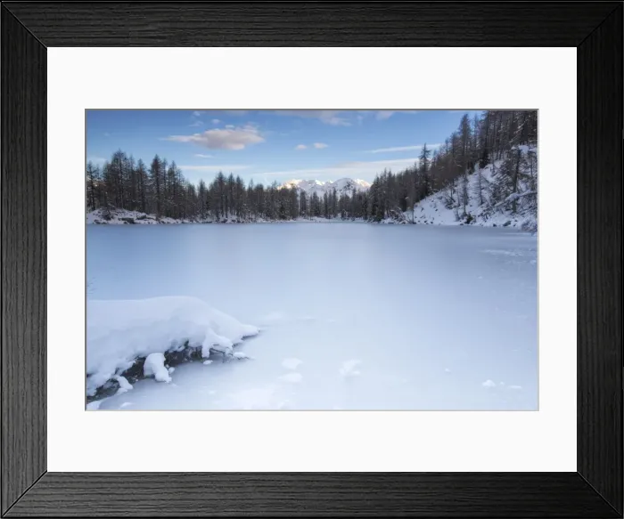 Framed Print : View of the frozen Lago Azzurro surrounded by snow at dawn, Spluga Valley, Province of Sondrio