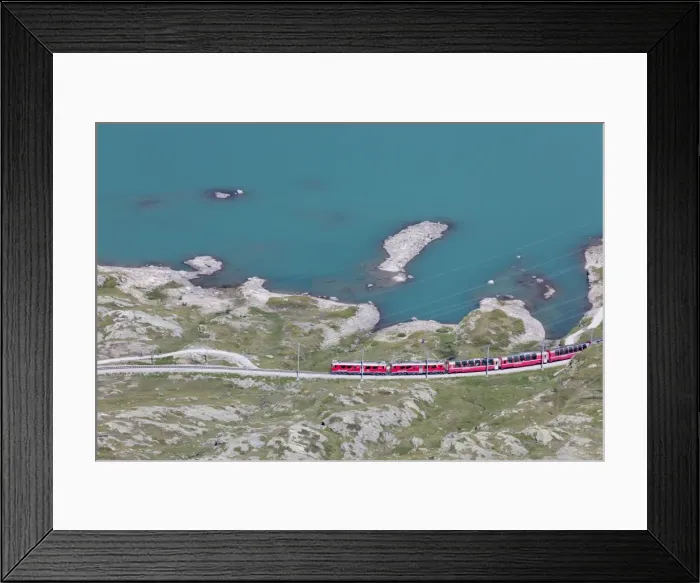 Framed Print : The Bernina Express train passes on the shores of Lago Bianco, Bernina Pass, Canton of Graubunden Framed Print : The Bernina Express train passes on the shores of Lago Bianco, Bernina Pass, Canton of Graubunden