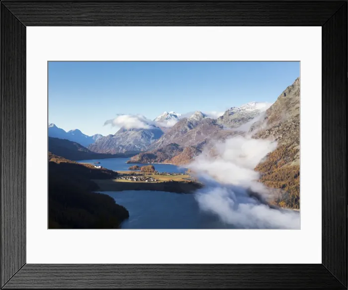 Framed Print : View of Sils and the blue lake surrounded by mist in autumn, Surlej, St Framed Print : View of Sils and the blue lake surrounded by mist in autumn, Surlej, St