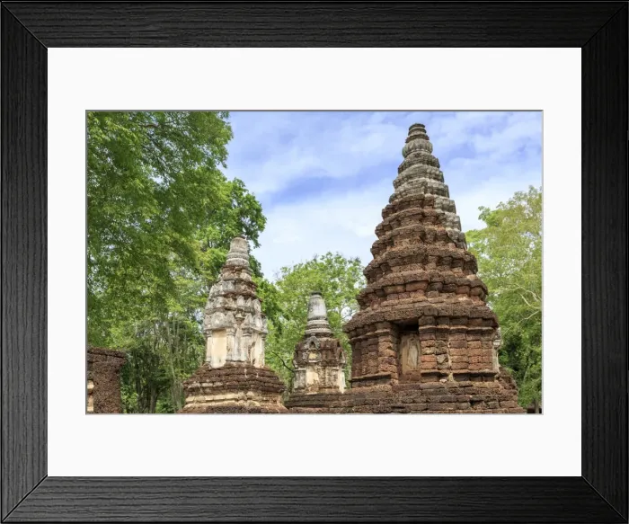 Framed Print : Buddhist chedis (stupas) and temple in Si Satchanalai Historical Park, Sukhothai Framed Print : Buddhist chedis (stupas) and temple in Si Satchanalai Historical Park, Sukhothai